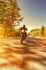 Fototapeta premium Man seat on the motorcycle on the forest road.