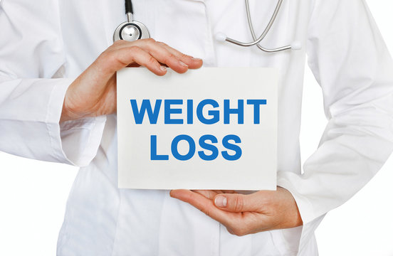 Weight Loss card in hands of Medical Doctor