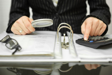 accountant is examining  invoices and documents