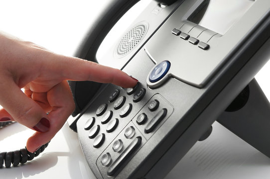 closeup of woman finger  dialing a telephone number to make a ph