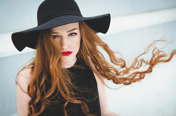 Young redhead woman with hat