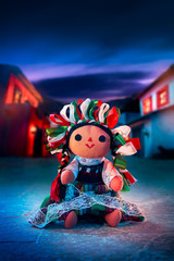Mexican rag doll in a traditional dress at night