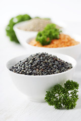 Bowls of assorted dried lentils with red lentils, black beluga l