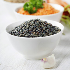 Bowls of assorted dried lentils with vegetables