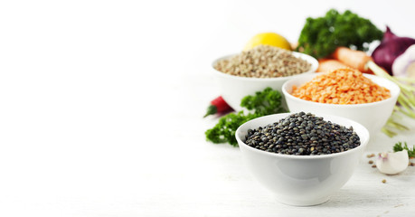Bowls of assorted dried lentils with vegetables