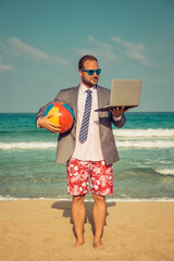 Funny businessman on the beach