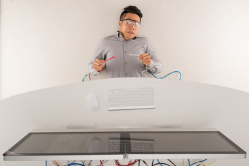 Asian software developer messed up cables, view from above