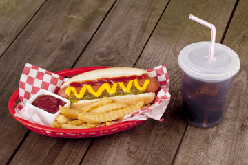 hotdog sandwich with fries and drinks