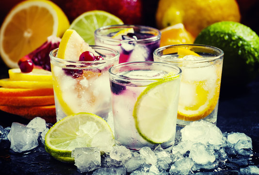 Chilled soft drinks with ice, citrus fruits and berries, black b