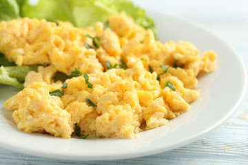 Scrambled eggs with vegetables on a blue wooden table