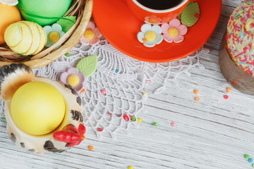 Table setting for Easter - Easter cakes, coffee cup and colored