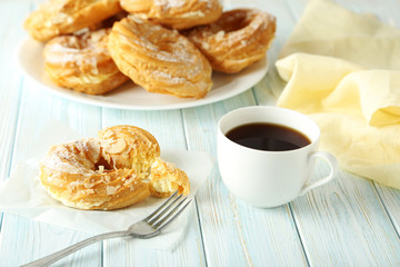Sweet eclairs on a white wooden table