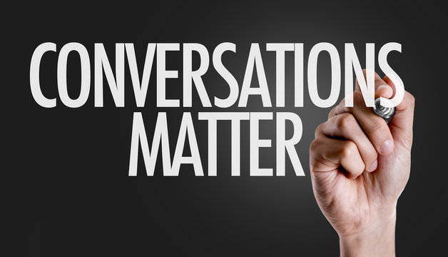 Hand writing the text: Conversations Matter