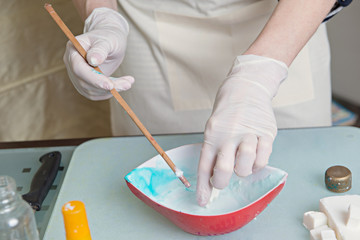 Woman's hands during homemade soap making