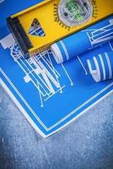 Rolls of blue engineering drawings level on metallic background