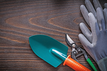 Rubber protective gloves hand shovel and secateurs on vintage wo