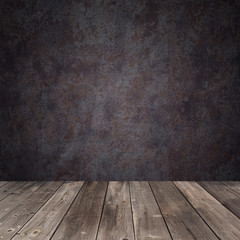 Empty wooden table against a dark wall
