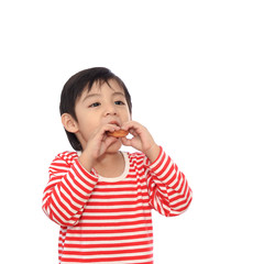 Little cute kid eating eating cookie