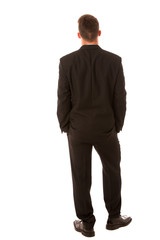 Successful businessman in formal suit confidently standing isola