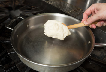 Preparing solid cheese in a pan, for Macaroni cheese