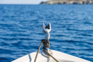 Boat sailing on the deep blue aegean sea. Close-up shot.