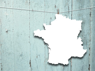 Close-up of one hanged France blank silhouette frame against aqua wooden boards background