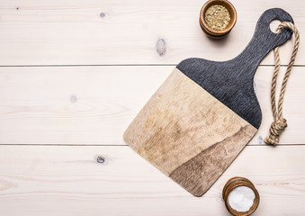 cutting board with spices on a wooden table accessories for cooking on wooden rustic background top view