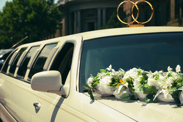 White wedding limousine decorated with flowers