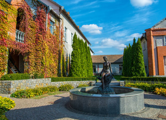 sculpture of a naked woman with a jug in the yard
