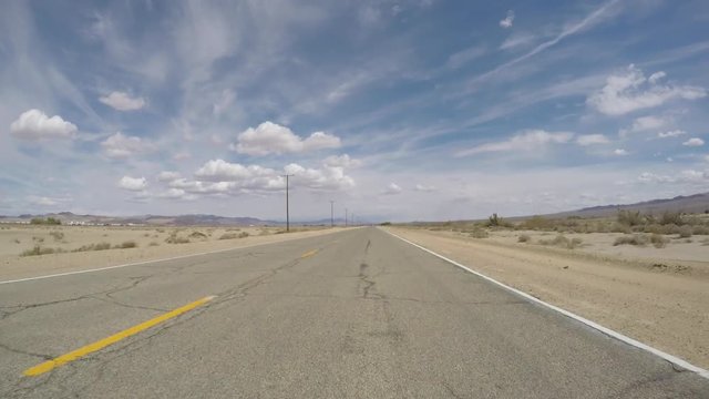 Old Route 66 rough road driving time lapse crossing the Southern California Mojave desert.