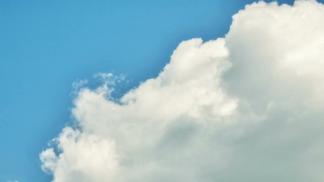 Timelapse with white fluffy clouds over blue sky. Nature background