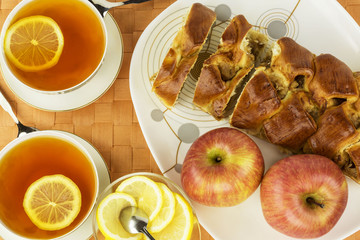 sweet cuts of apple pie  with  lemon tea