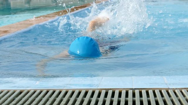 Young Asain boy swimming in swimming pool