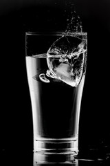 Water splash ice dropped in a glass