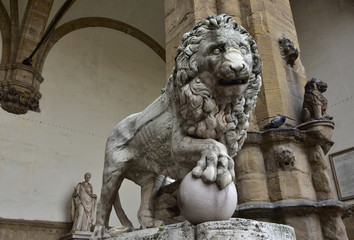 Medici Lion holds the globe in Piazza della Signoria. Marble lion statue at the entrance (right side) of Loggia dei Lanzi in Florence, an ancient roman sculputure from 2nd century