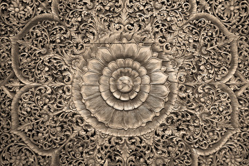 Fototapeta na wymiar Pattern of flower carved on wood background