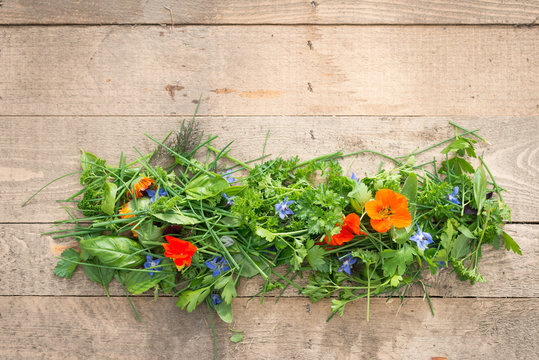 Heap of Edible Flowers and Herbs on Wooden Planks