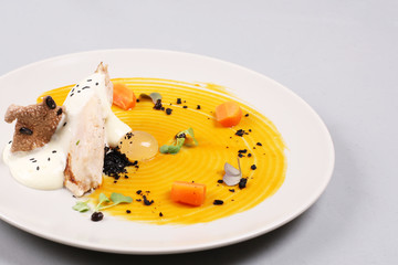 chicken breast with vegetables on a white plate.