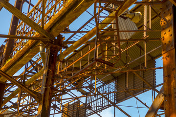 Ruins of an abandoned old factory. The remains of the steel stru