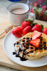 healthy breakfast waffle with strawberry  and chocolate syrup on
