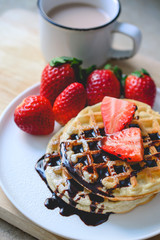 healthy breakfast waffle with strawberry  and chocolate syrup on
