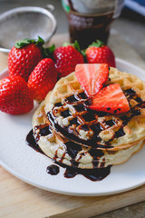 healthy breakfast waffle with strawberry  and chocolate syrup on