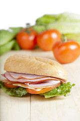 ham sandwich with blurred tomato background