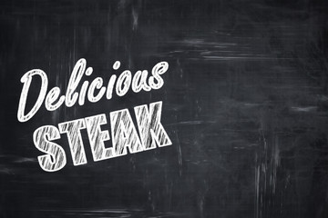 Chalkboard background with chalk letters: Delicious steak sign