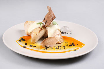 chicken breast with vegetables on a white plate.