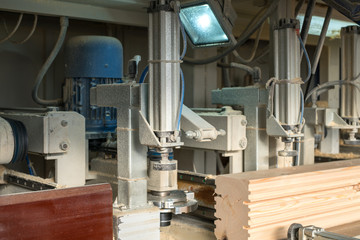 Sawmill. Image of shaped timber cutting on machine