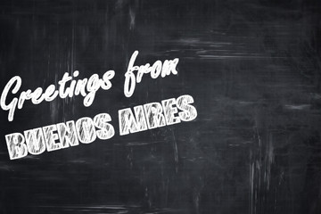 Chalkboard background with chalk letters: Greetings from buenos 