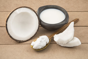 Oil and coconut cream on wooden background