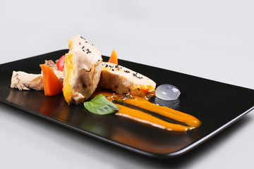 chicken breast with vegetables on a white plate.