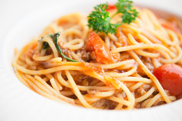 Healthy plate of Italian spaghetti topped with a tasty tomato and ground beef